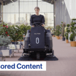 The text Sponsored Content over an image of a woman driving a Nilfisk SW3000 Ride-On Sweeper.