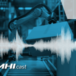 Automated arm moving boxes off a conveyor belt.